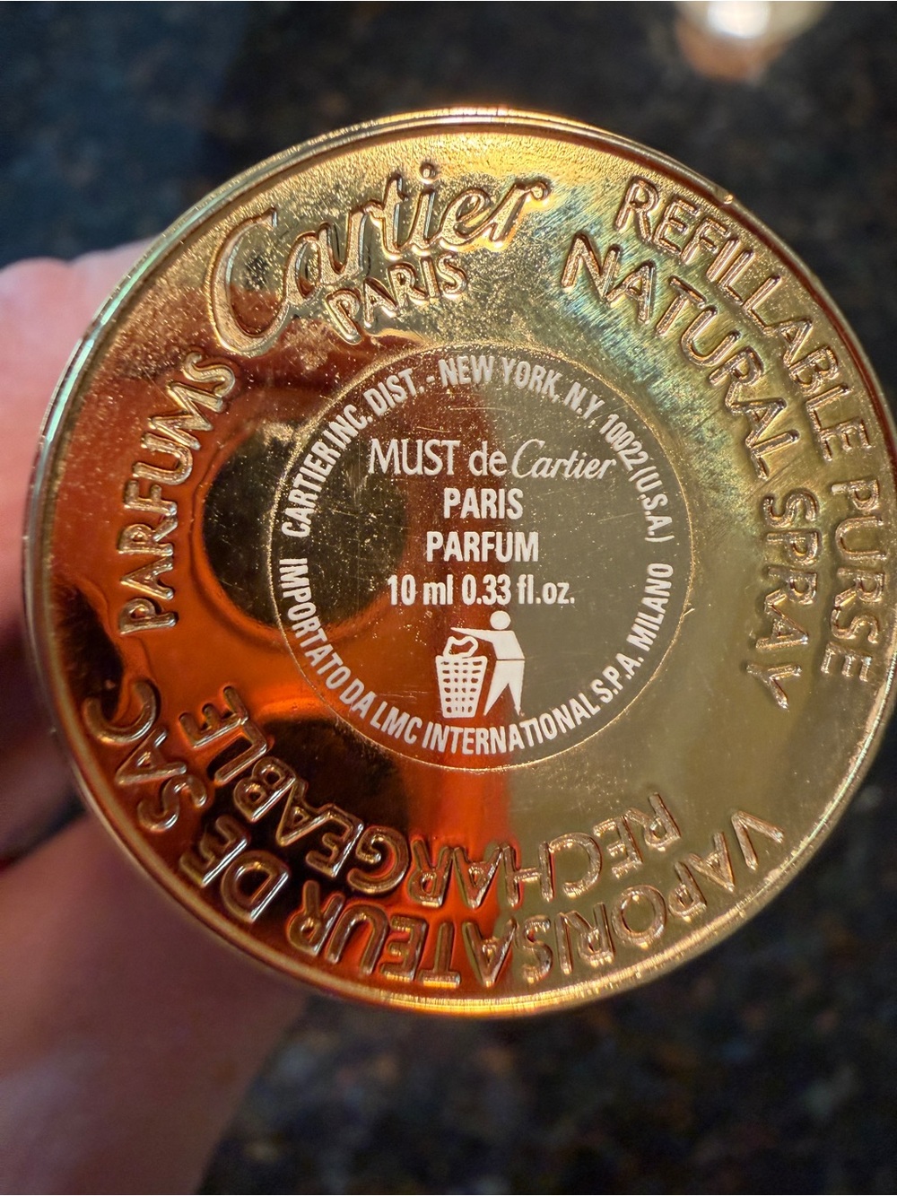 Vintage Cartier gold travel perfume canister with embossed logo
